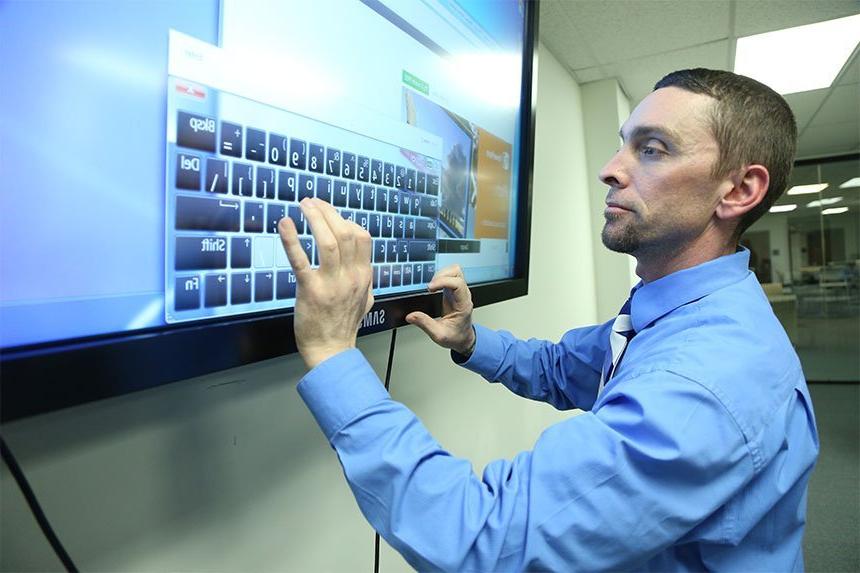 Student using keyborard on TV